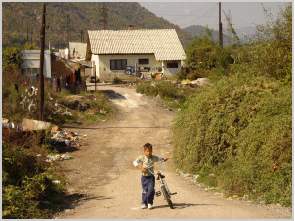 Boy on bicycle leaving Cesmin Lug, Kosovo